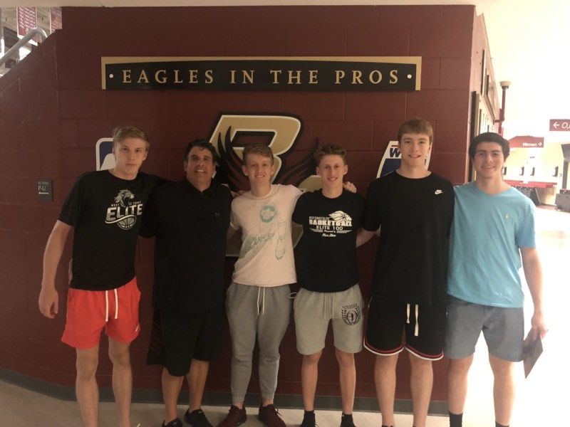 Tour athletes at Boston College beneath the Eagles in the Pros wall.