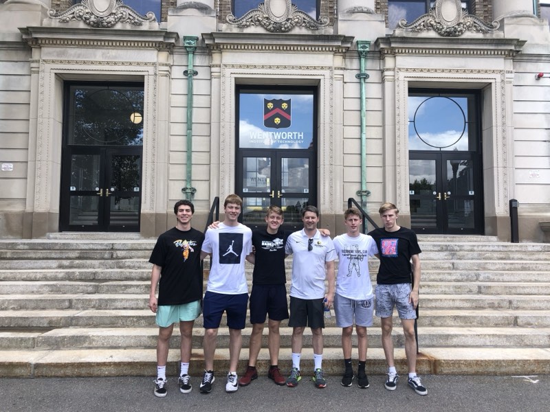 Tour athletes on the steps of Wentworth Institute of Technology.